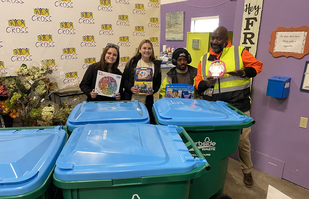 Photo of kids with book gifts from Curbside Waste to support our community.